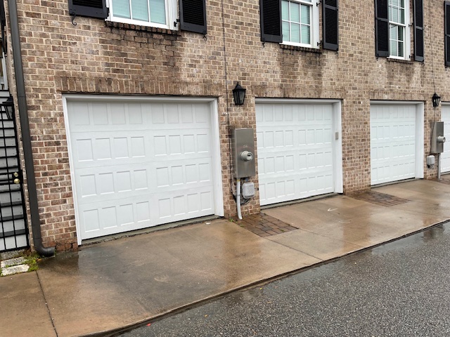 three white garage doors in residential home